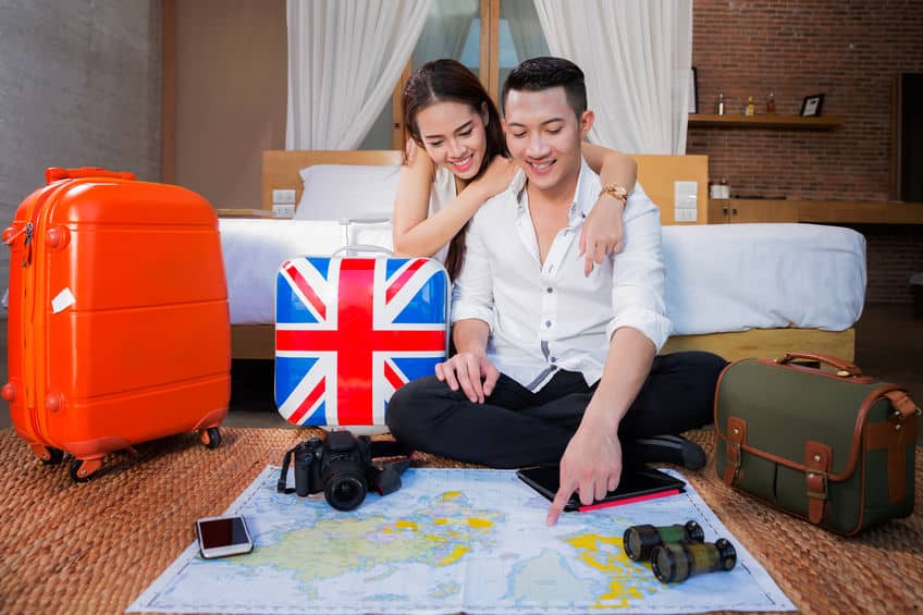 young couple planning honeymoon vacation trip